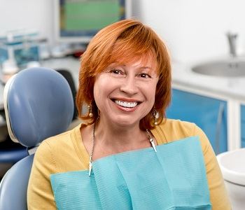 woman feeling comfortable and smiling at the dentist's